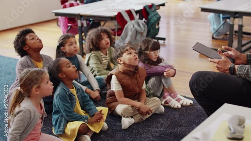 Phonetics lesson in a first grade class: Elementary school children participating in a class activity with their teacher