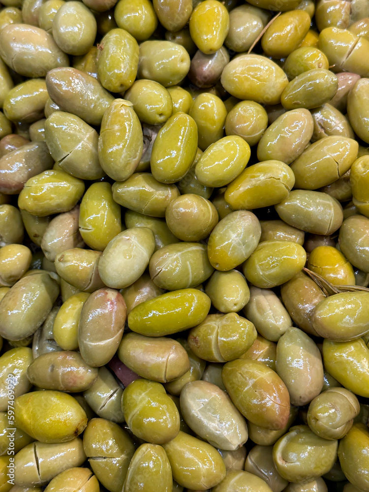Green olives. Heap of organic olives. Close up. Food background. Top view Green olives. Heap of organic olives. Close up. Food background. Top view