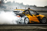 Motin Blurred car drifting on asphalt racing track with lot of smoke, motion blur drift caron Blur side view drift car