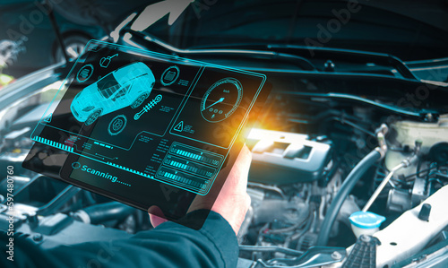 Auto mechanic checking engine system with OBD2 wireless scanning tool and car information showing on screen interface,Car maintenance service concept.