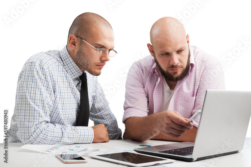 Team of serious businesspeople working on office desk