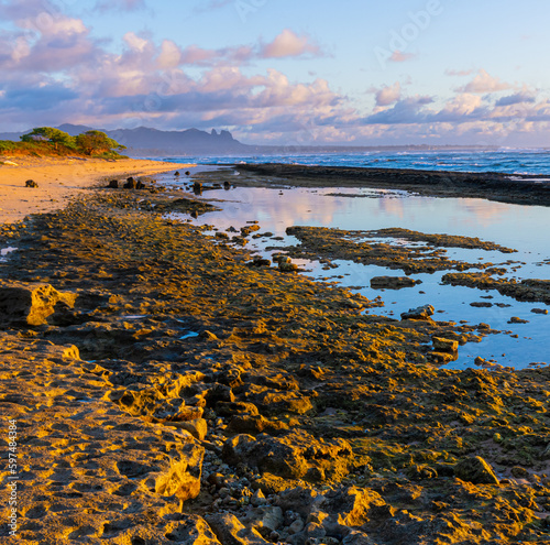 Early Morning Light Reflection on Tide Pools With Sleeping Giant Mountain in The Distance, Nukolii Beach, Kauai, Hawaii, USA