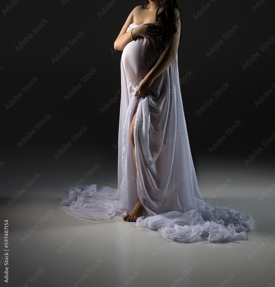 pregnant woman in white dress on a grey background, studio pregnancy shoot pregnant woman in white dress on a grey background, studio pregnancy shoot
