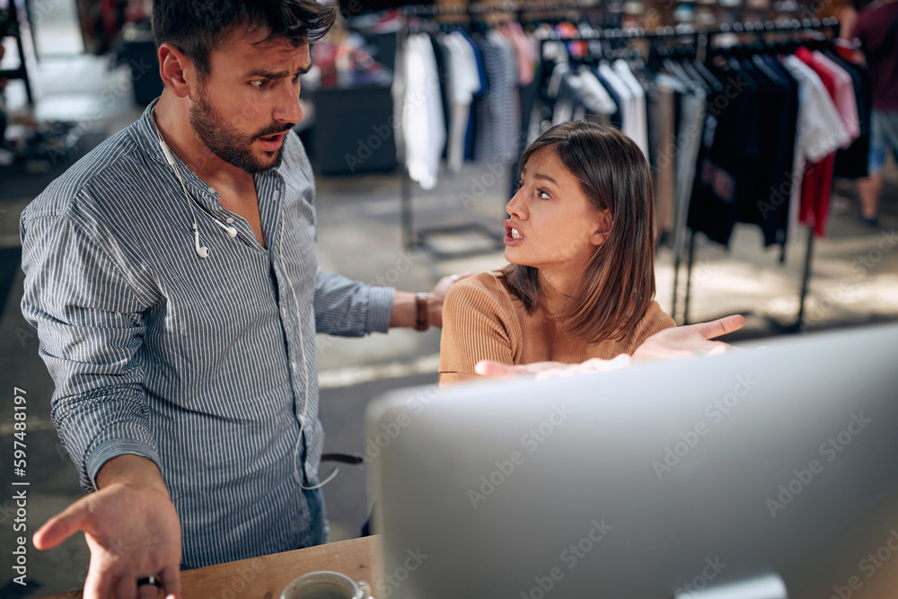 Annoyed and angry man and woman arguing over computer desktop at work about project not going well. Annoyed and angry man and woman arguing over computer desktop at work about project not going well.