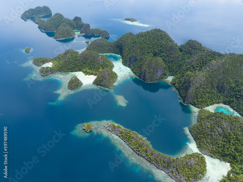 Beautiful coral reefs surround the dramatic limestone islands that rise from Raja Ampat's seascape. This remote part of Indonesia is known for its incredible marine biodiversity.