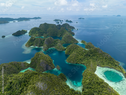 Beautiful coral reefs surround the dramatic limestone islands that rise from Raja Ampat's seascape. This remote part of Indonesia is known for its incredible marine biodiversity.