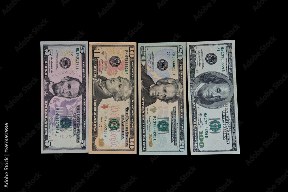 american dollars lie on a black background