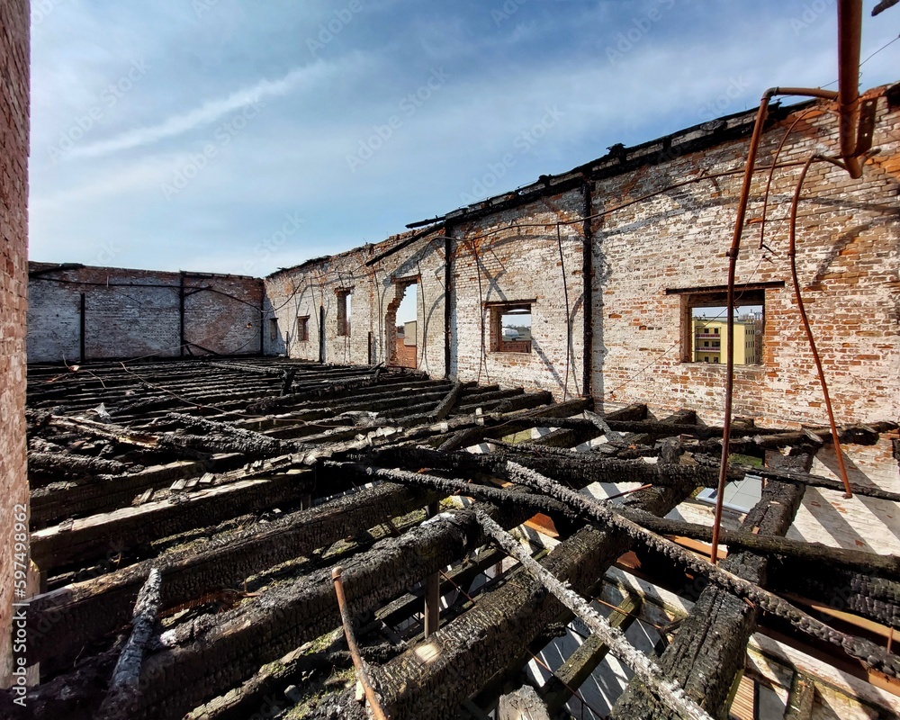 Fototapeta premium On top of a burnt warehouse with multiple storeys