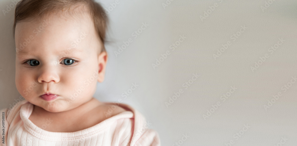 portrait of a newborn baby close-up. A baby with big blue eyes. Advertisement Banner With Cute Child. Panorama With Copy Space For Your Text