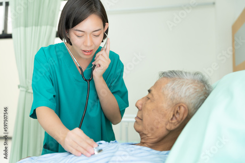 Elderly man talk to doctors and nurses in the hospital. senior male happy after receiving treatment and care and practice walk from a professional doctor. health care  physical therapy  nursing home