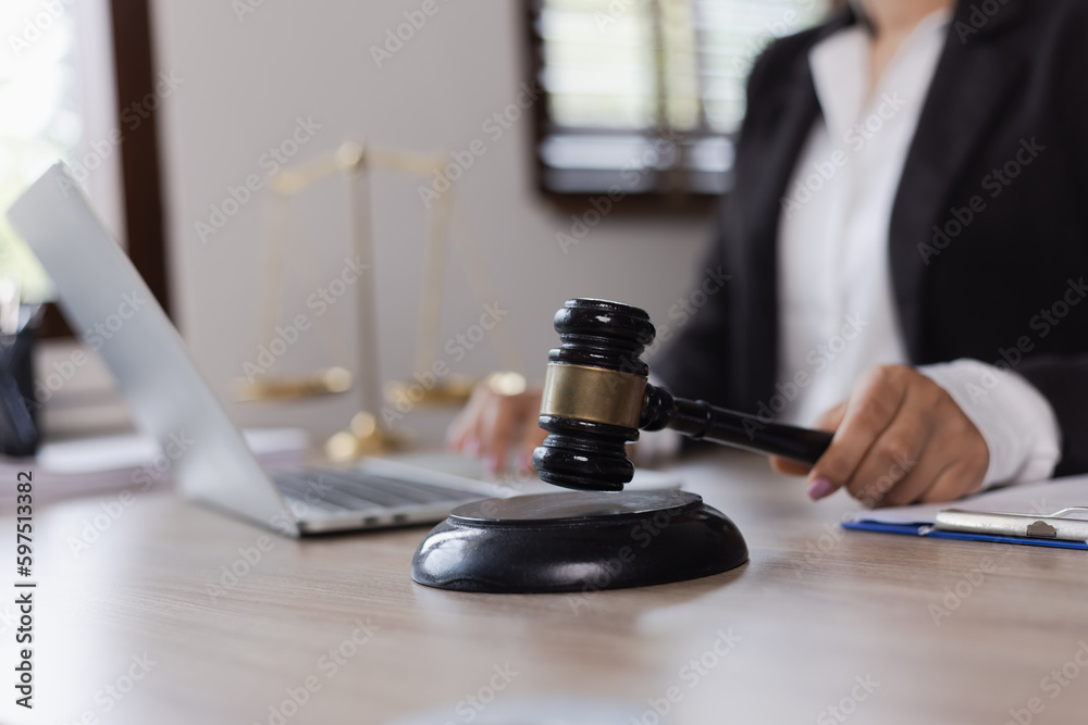 Advice and Legal services Concept. Judge gavel with Justice lawyers, Businesswoman in suit or lawyer working with laptop at desk. Advice and Legal services Concept. Judge gavel with Justice lawyers, Businesswoman in suit or lawyer working with laptop at desk.