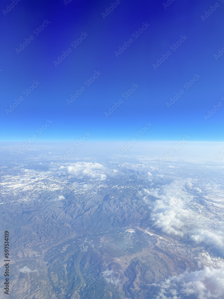 The plane flies in the sky. Aircraft wing. Travel concept. Flight and travel, view from the airplane window. 