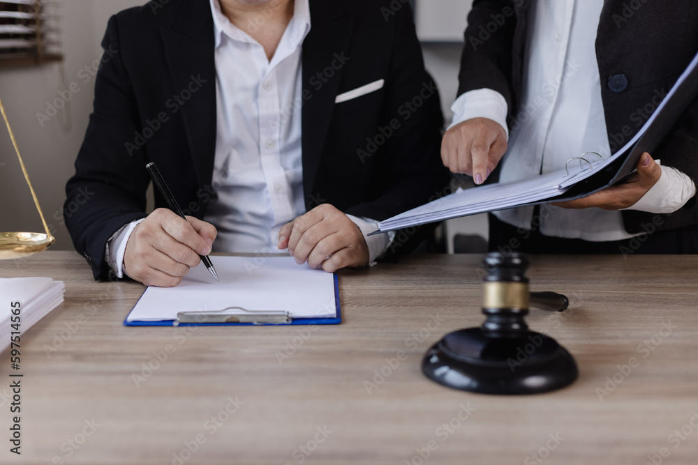 Close-up of asian lawyer and client discussing at office desk, law and justice concept. Close-up of asian lawyer and client discussing at office desk, law and justice concept.