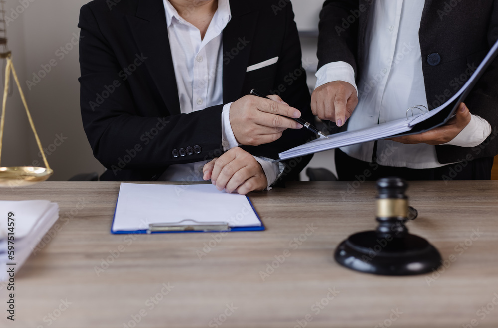 Close-up of asian lawyer and client discussing at office desk, law and justice concept. Close-up of asian lawyer and client discussing at office desk, law and justice concept.