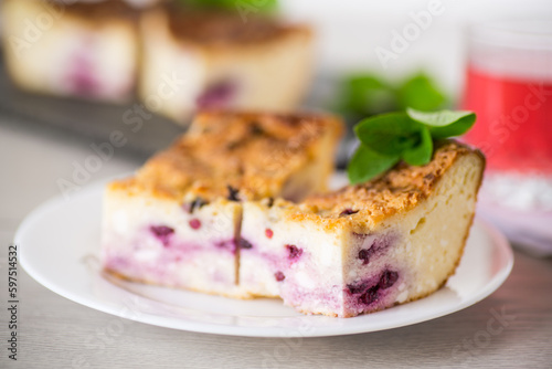 cooked cottage cheese casserole with berry filling in a plate