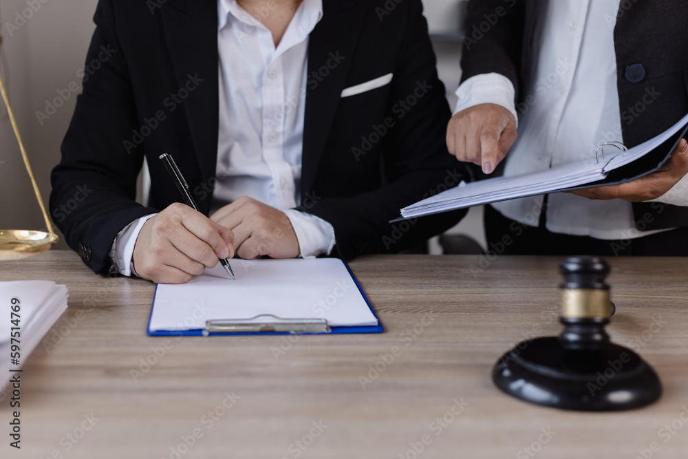 Close-up of asian lawyer and client discussing at office desk, law and justice concept. Close-up of asian lawyer and client discussing at office desk, law and justice concept.