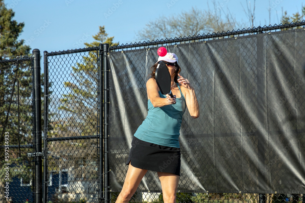 Female Pickleball Player Returning High Volley Female Pickleball Player Returning High Volley