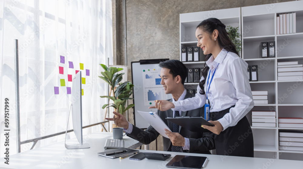 Two employees working at table in a modern office, Asian man and a woman work at office desk, Business campaign result and project planning concept, financial planning, Two employees working at table in a modern office, Asian man and a woman work at office desk, Business campaign result and project planning concept, financial planning,