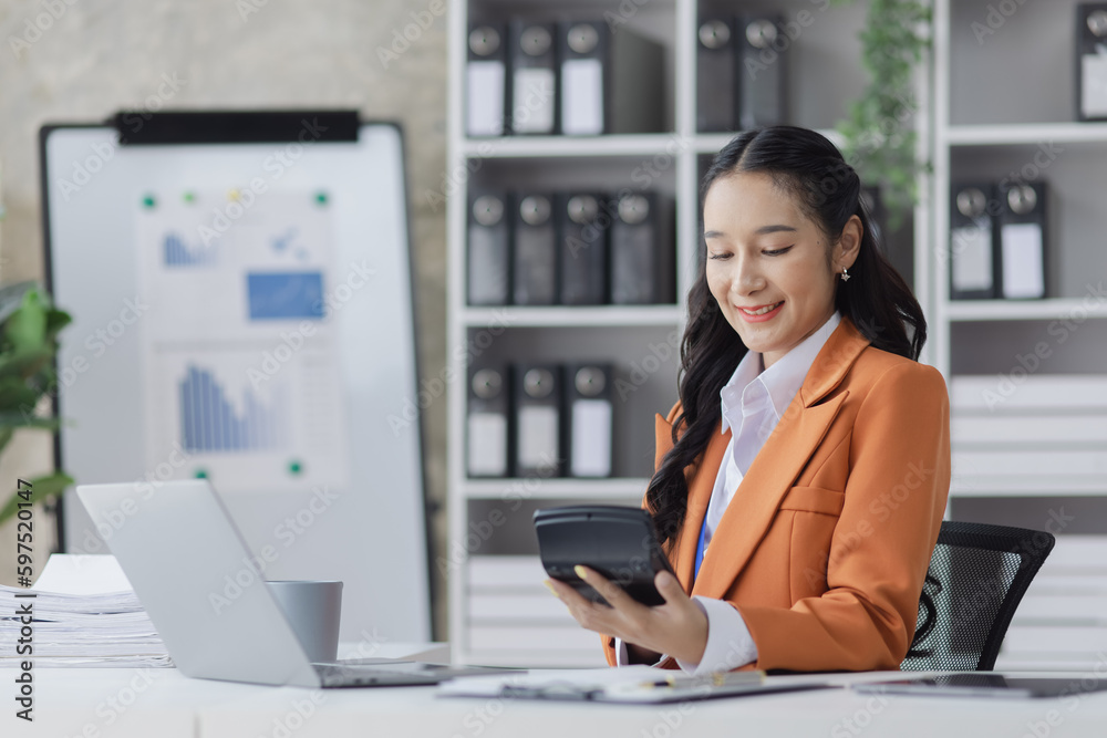 Asian businesswoman working on e-Commerce project marketing, Business and investment finance with growth graph. Asian businesswoman working on e-Commerce project marketing, Business and investment finance with growth graph.