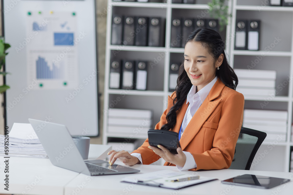 Asian businesswoman working on e-Commerce project marketing, Business and investment finance with growth graph. Asian businesswoman working on e-Commerce project marketing, Business and investment finance with growth graph.