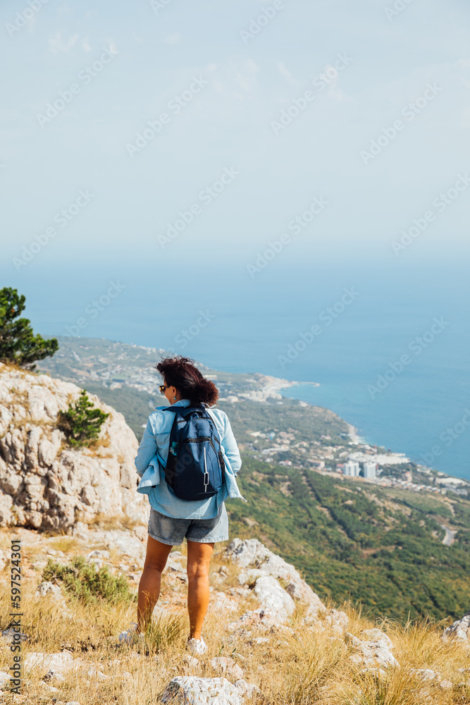 Naklejka premium a woman on a mountain hiking beautiful nature journey
