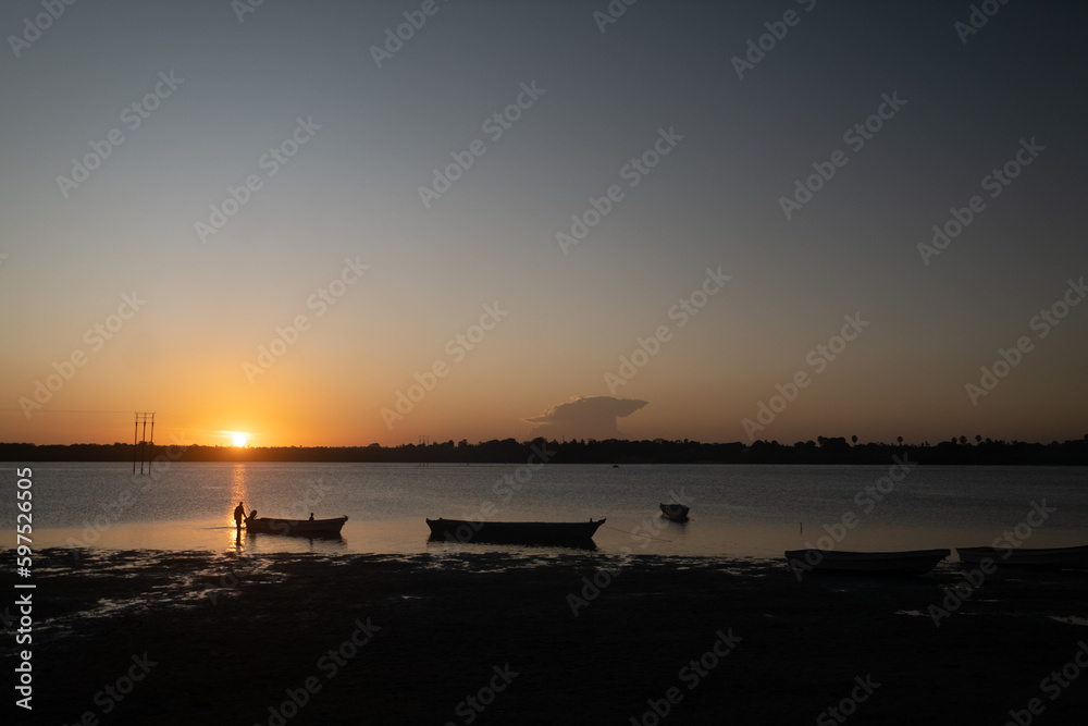 sunset over the Atlantic Ocean and fishing boats sunset over the Atlantic Ocean and fishing boats