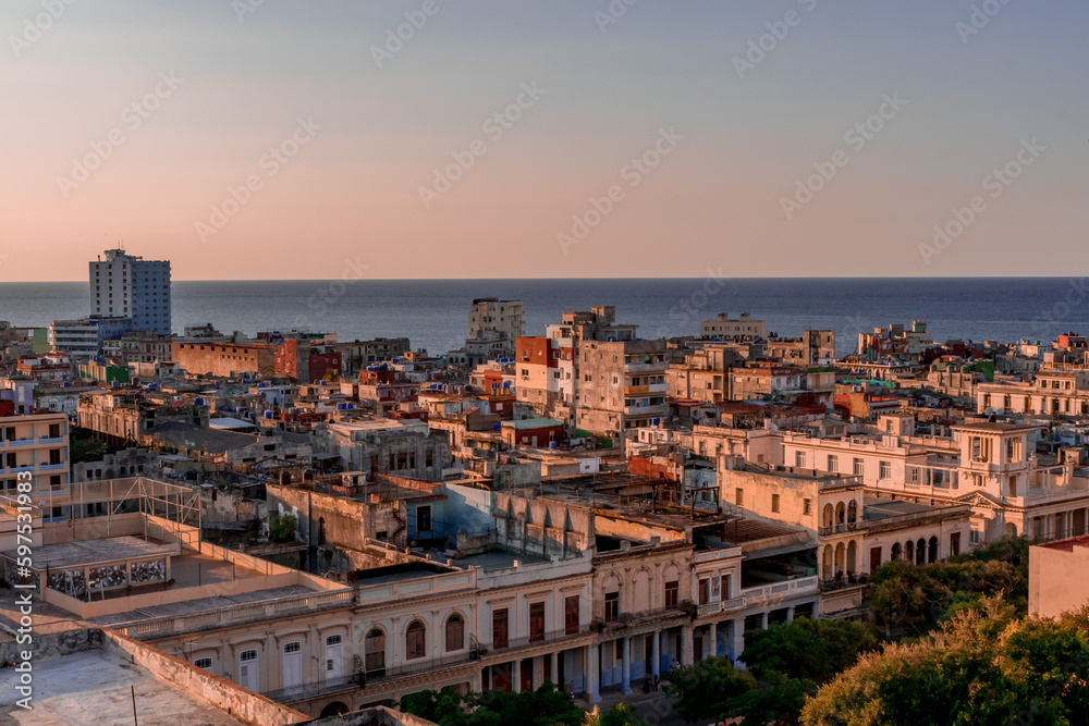View over the rooftops of Havana in Cuba at sunset with the sea