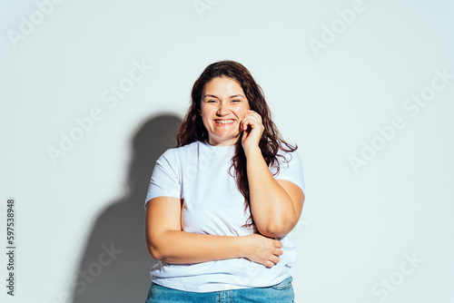 Plus size woman model posing in studio and having fun