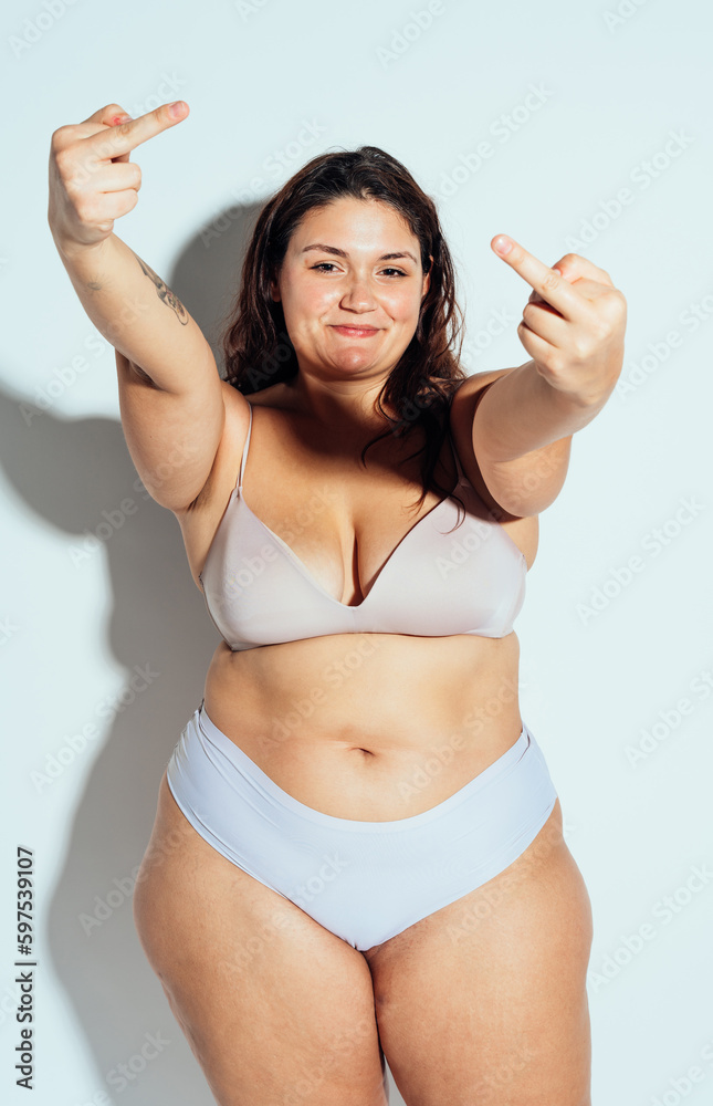 Plus size woman posing in studio in lingerie Plus size woman posing in studio in lingerie