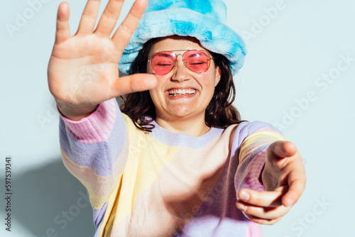 Plus size woman model posing in studio and having fun.