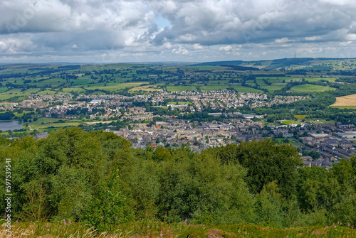 The View overlooking Otley Town in West Yorkshire seen from the wooded Chevin ridge to the south of the Town, with green fields in the background. © Julian