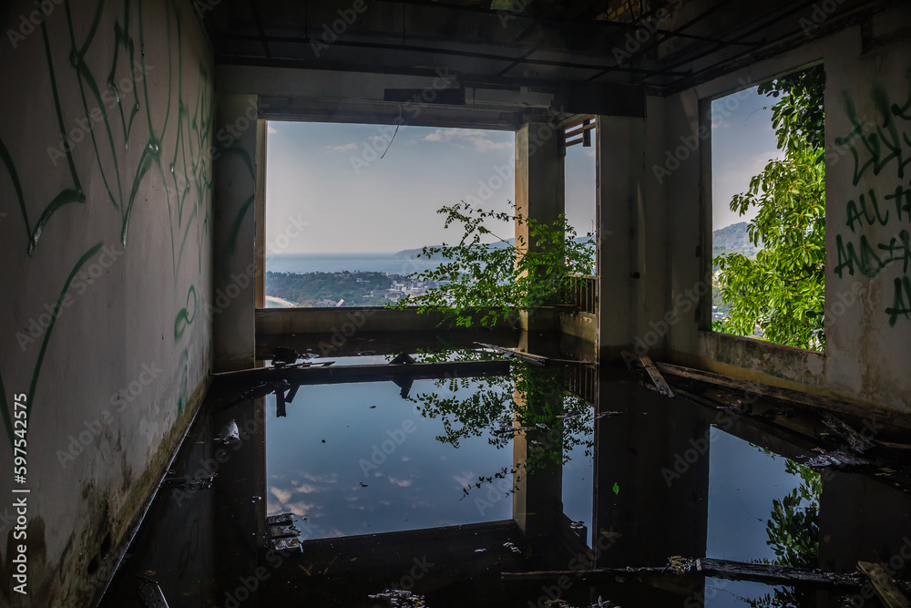 Gloomy interiors of an abandoned building. Empty room. Graffiti on the walls. Concrete room. Terrible abandoned hotel. Gloomy interiors of an abandoned building. Empty room. Graffiti on the walls. Concrete room. Terrible abandoned hotel.