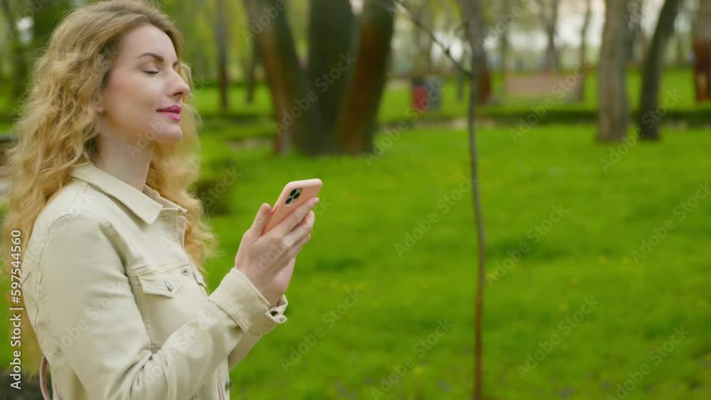 Outdoor, phone scroll and woman walking in park swiping on smartphone for rest and relax outside. Female lady smiling walk in nature, fresh air for balance, break and energy or social media, internet Outdoor, phone scroll and woman walking in park swiping on smartphone for rest and relax outside. Female lady smiling walk in nature, fresh air for balance, break and energy or social media, internet