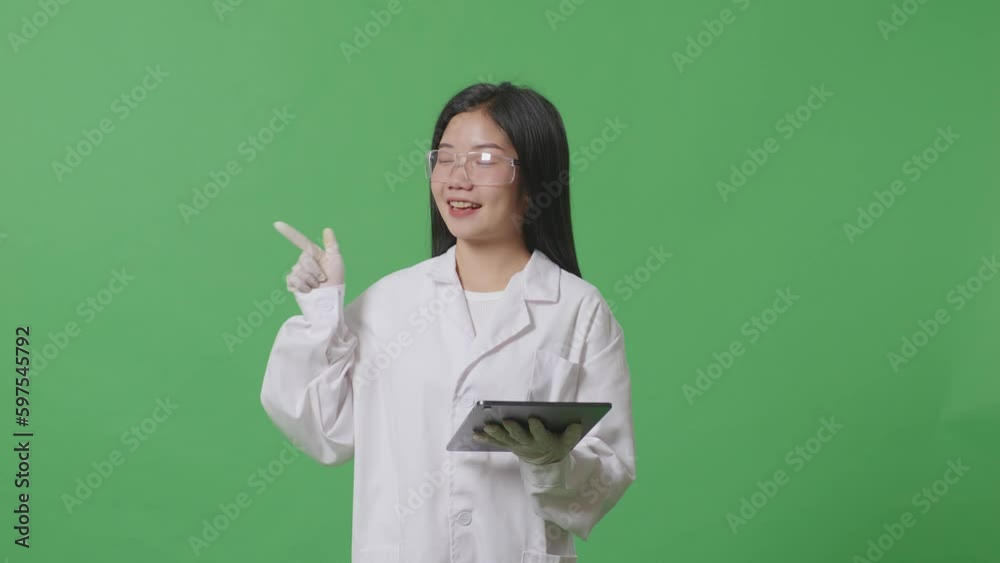 Asian Woman Scientist With A Tablet Smiling And Pointing To Side While Standing On The Green Screen Background In The Laboratory
Asian Woman Scientist With A Tablet Smiling And Pointing To Side While Standing On The Green Screen Background In The Laboratory