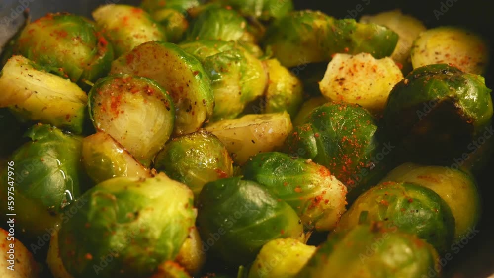 Olive oil is poured on Brussels sprouts. Home-fried Brussels sprouts with red paprika spice. Delicious nutritious dish. Healthy vegetarian food Olive oil is poured on Brussels sprouts. Home-fried Brussels sprouts with red paprika spice. Delicious nutritious dish. Healthy vegetarian food