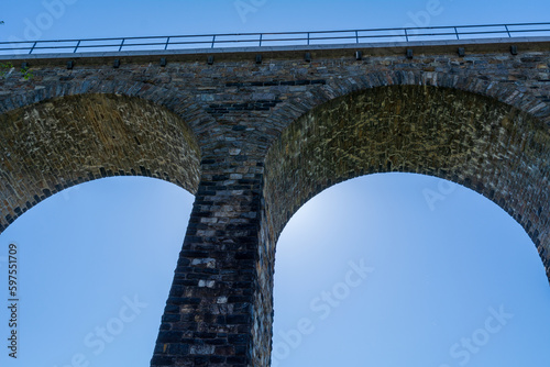 Obraz na płótnie Historic stone railway viaduct on a sunny day against a blue sky w salonie