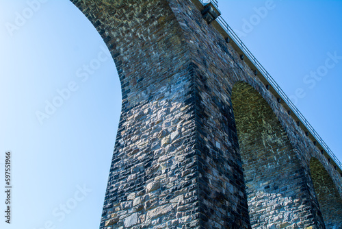 Obraz na płótnie Historic stone railway viaduct on a sunny day against a blue sky w salonie