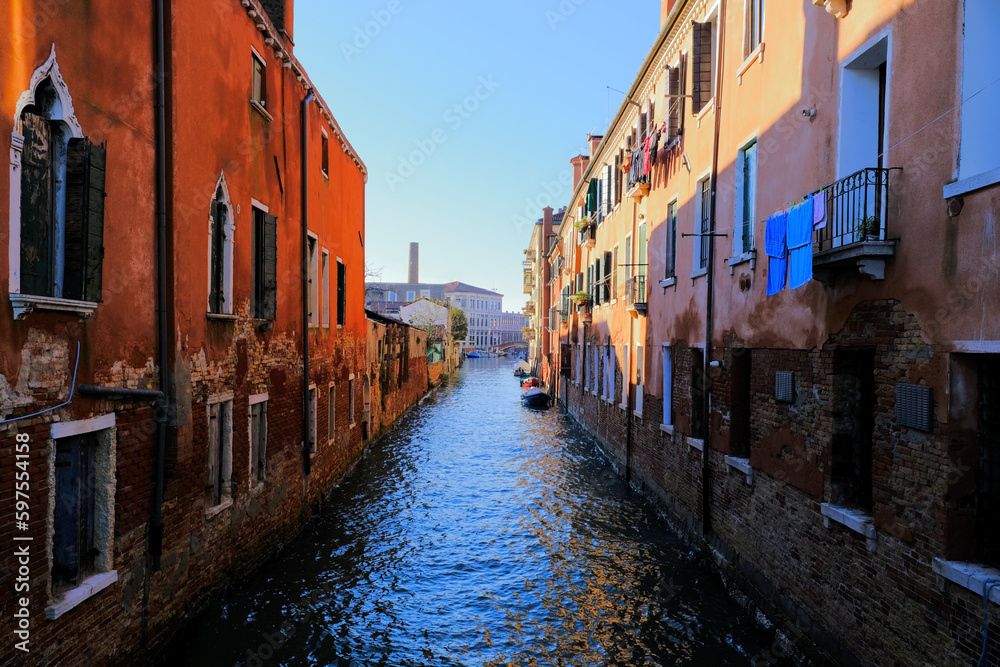 Narrow canal between old residential buildings in Venice, Italy