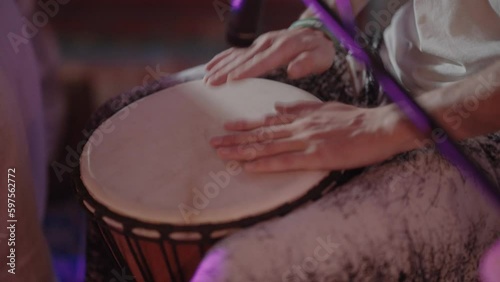 men's hands on the drum is a very close-up, in which men's hands beat the rhythm on a hand drum covered with leather.