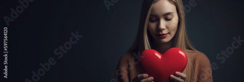 A girl holding a heart in her hand