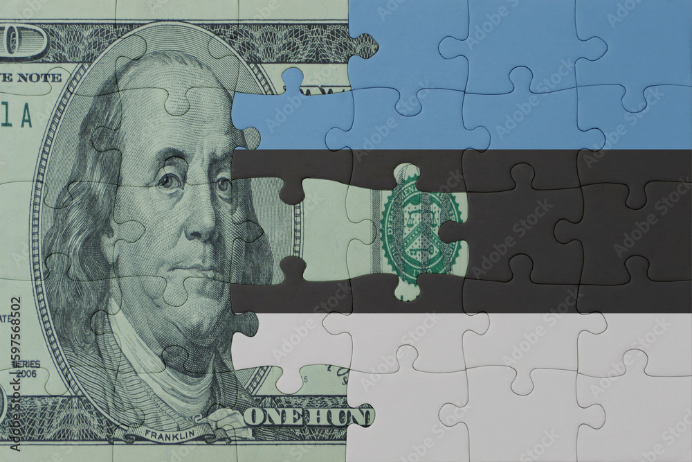 puzzle with the national flag of estonia and dollar money banknote. macro.concept.