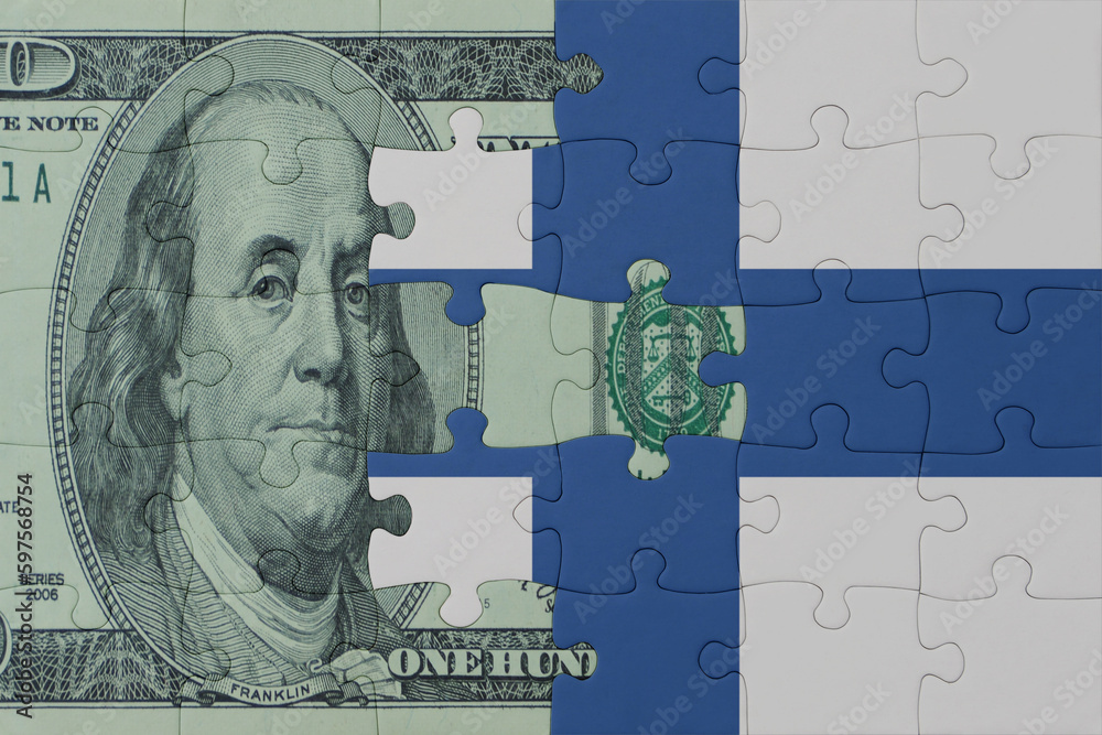 Fototapeta premium puzzle with the national flag of finland and dollar money banknote. macro.concept.