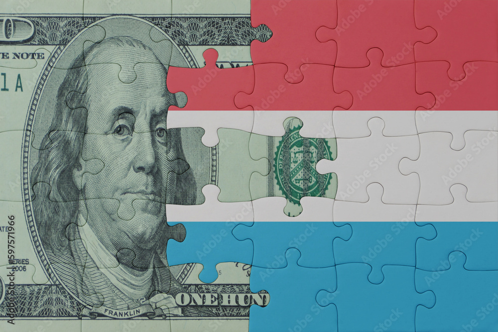 puzzle with the national flag of luxembourg and dollar money banknote. macro.concept.