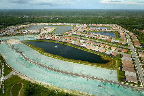 View from above of densely built residential houses under construction in closed living clubs in south Florida. American dream homes as example of real estate development in US suburbs