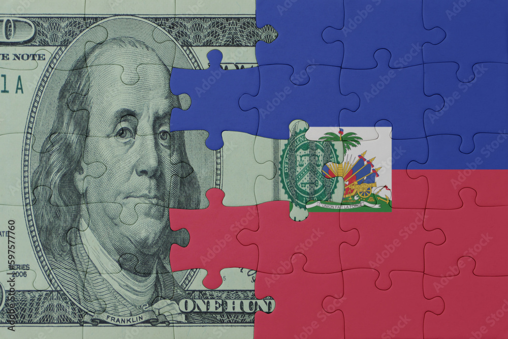 puzzle with the national flag of haiti and dollar money banknote. macro.concept. puzzle with the national flag of haiti and dollar money banknote. macro.concept.
