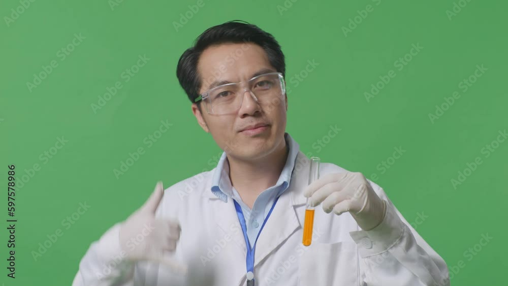 Close Up Of Asian Man Scientist With Orange Liquid In The Test Tube ...