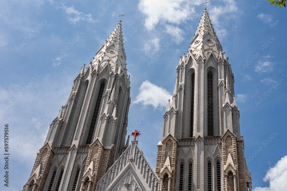 Exterior facade of a neo gothic church with and cloudy sky in background Exterior facade of a neo gothic church with and cloudy sky in background