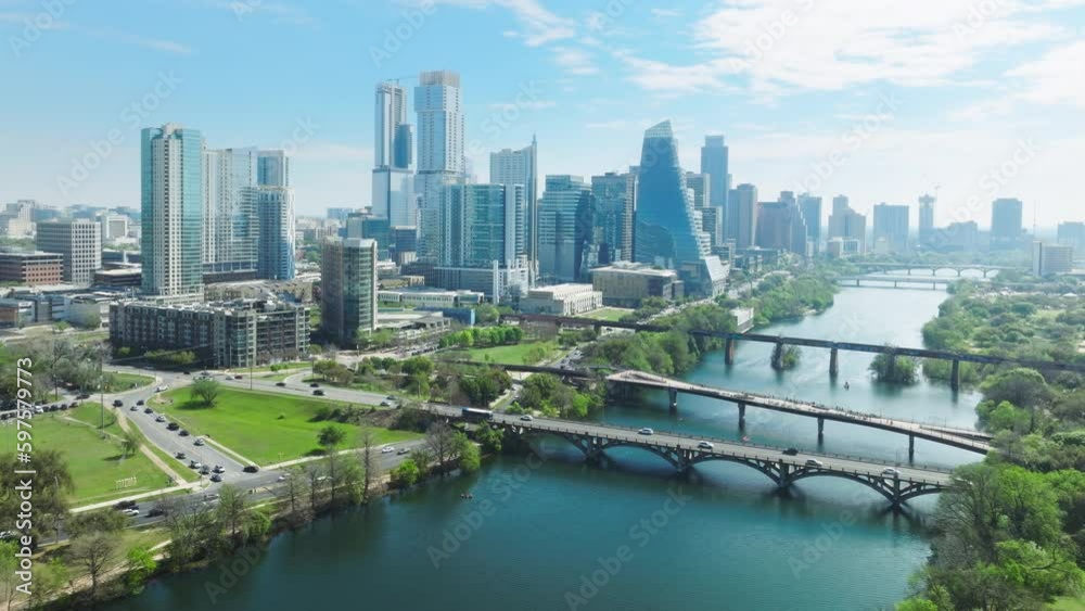 Austin Texas USA aerial drone footage of Colorado river parks with Downtown skyscrapers on cinematic background. Financial and residential buildings cityscape view on sunny summer day, 4K footage USA
