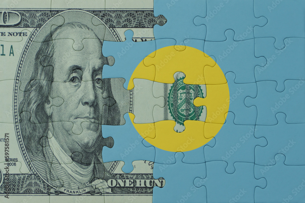 puzzle with the national flag of Palau and dollar money banknote. macro.concept. puzzle with the national flag of Palau and dollar money banknote. macro.concept.