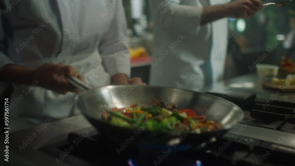 chefs cooking in industrial kitchen, putting butter in frying pan in slow motion chefs cooking in industrial kitchen, putting butter in frying pan in slow motion